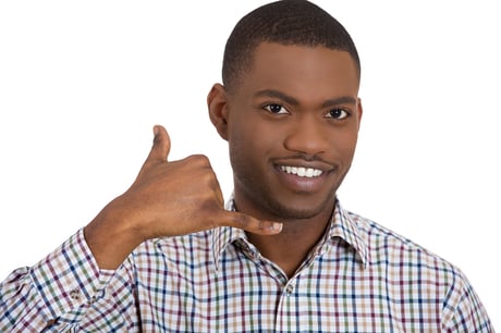 Closeup portrait of young single man, handsome happy student, worker making call me gesture sign with hand shaped like phone, isolated on white background. Positive human emotions, face expressions